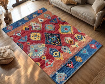 May include: A colorful rug with a geometric pattern in shades of red, blue, yellow, and orange. The rug has a traditional, tribal design with intricate details.