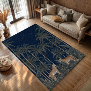 May include: A rectangular area rug with a dark blue background featuring a palm tree design and two leopards. The rug has a tropical theme, with a night sky design and a detailed illustration.