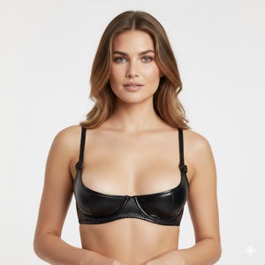 May include: A black, open-bust bra with adjustable straps and a delicate underwire. The bra is made of a shiny, faux leather material and features a subtle bow detail on the straps. The design offers minimal coverage.