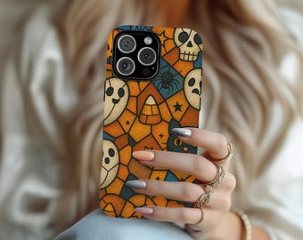 May include: A Halloween-themed phone case featuring a repeating pattern of ghosts, skulls, spiders, candy corn, and black cats. The case has a mosaic-like design with orange, blue, and cream colors.