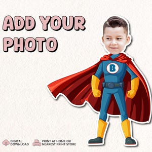 May include: Printable superhero cutout with a red cape and blue costume. The cutout has a space for a photo to be added. The text "ADD YOUR PHOTO" is at the top of the image.