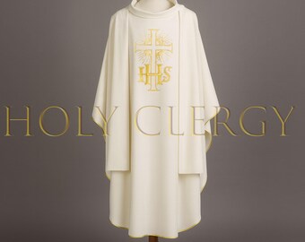 May include: Cream-colored liturgical vestment with gold embroidery of a cross and the letters IHS. The vestment has a high collar and a layered design, with gold trim along the bottom edge. The text "HOLY CLERGY" is visible.