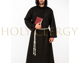May include: Black hooded robe with long sleeves and a white rope belt. The robe is worn with a red book. The text "HOLY CLERGY" is displayed in gold lettering.