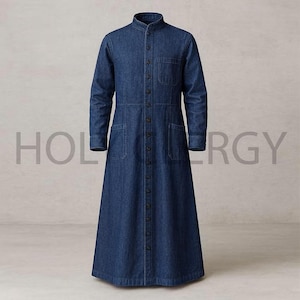 May include: A long, button-down denim dress in a medium blue wash. The dress features a mandarin collar, long sleeves, and multiple pockets. The text "HOLERGY" is faintly visible in the background.
