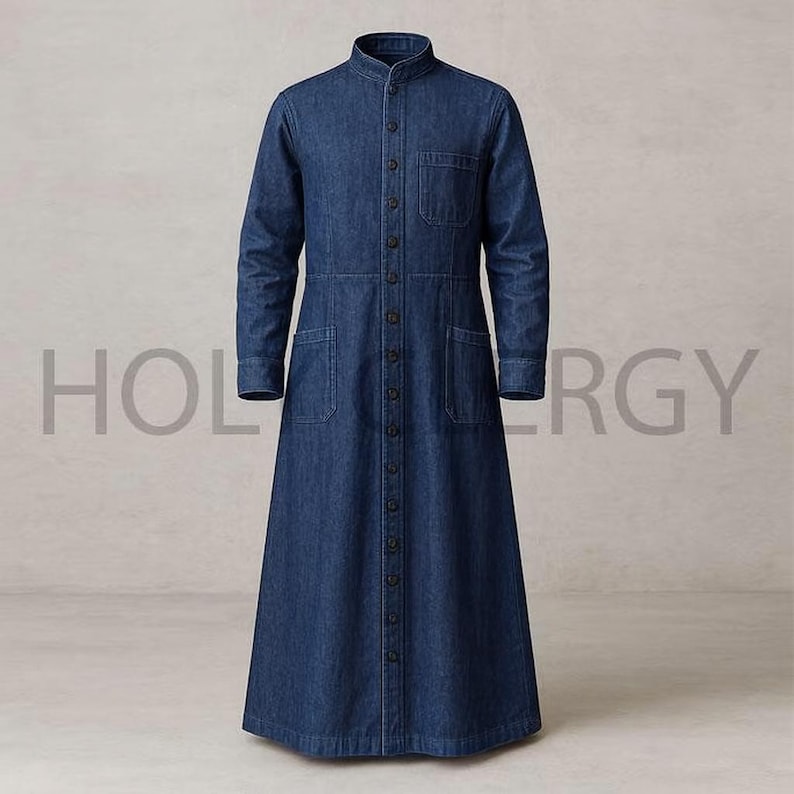 May include: A long, button-down denim dress in a medium blue wash. The dress features a mandarin collar, long sleeves, and multiple pockets. The text "HOLERGY" is faintly visible in the background.