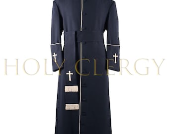 May include: A navy blue clergy robe with white trim and cross details. The robe features a mandarin collar, a matching belt, and decorative tassels. The text "HOLY CLERGY" is visible in the background.