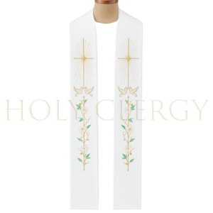 May include: White clergy stole with gold embroidered cross, doves, and floral design. The stole has the text "HOLY CLERGY" in a light gold color. The stole is made of a soft, flowing fabric.