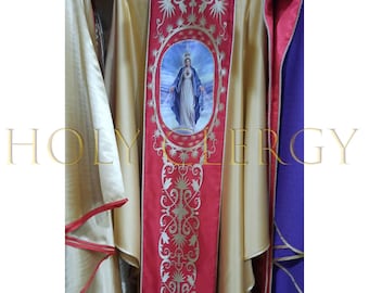 May include: A gold-colored liturgical vestment with a red panel featuring an image of a religious figure. The panel is adorned with gold embroidery and a decorative border. The text "HOLY LERGY" is visible in the image.