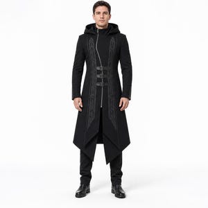 May include: A black hooded long coat featuring an asymmetrical silver zipper closure, three horizontal buckle straps across the chest, and intricate grey embroidery panels running vertically along the front, paired with matching black trousers.