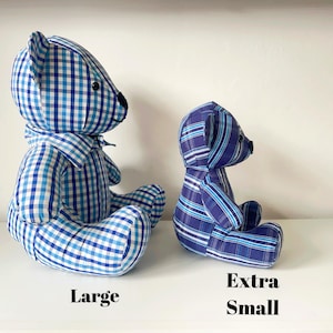 May include: Two handmade teddy bears in blue and white checkered and striped fabrics. The larger bear is labeled "Large" and the smaller bear is labeled "Extra Small". Both bears are sitting on a white surface.