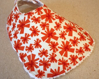 The Dressy Drooler Bib in Orange and Red Asterisk print