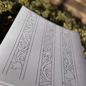 May include: Three black and white line drawings of decorative patterns on a white sheet of paper. The patterns are made up of swirls and curves. The bottom pattern has a measurement of 1/2 inch.