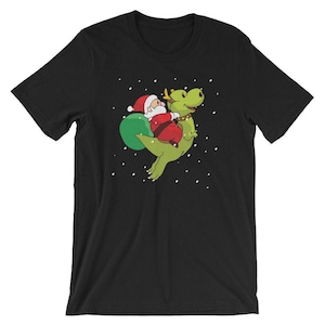 Santa Claus Riding T-Rex T-Shirt Rudolph Reindeer Dinosaur Christmas Tee Unisex Women Men Kids Holiday Gift Idea