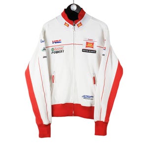 May include: White zip-up jacket with red trim and various sponsor logos, including "HRC", "Castrol", "POWER", "San Carlo", and "Honda Dream".