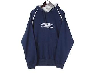 May include: A navy blue hooded sweatshirt with white trim and a white logo that says "UMBRO" with a diamond shape above the text.