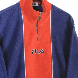 May include: A trio of ceramic mugs with a speckled, matte finish in cream, light grey, and dark grey. Each mug features a simple, minimalist design, ideal for tea or coffee.