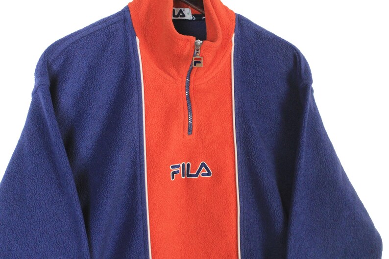 May include: A trio of ceramic mugs with a speckled, matte finish in cream, light grey, and dark grey. Each mug features a simple, minimalist design, ideal for tea or coffee.