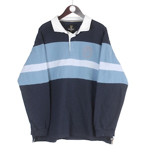 May include: A long-sleeved rugby shirt in navy blue, light blue, and white stripes. The shirt has a white collar and a small logo near the collar. The shirt is hanging on a wooden hanger.