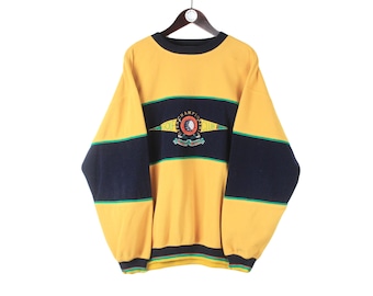 May include: Yellow, blue, and green striped sweatshirt with a large embroidered logo that says "Champion" on the front.