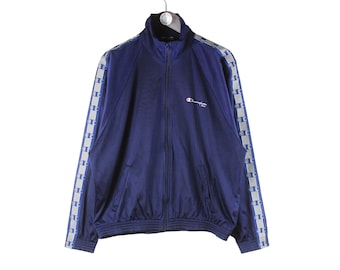 May include: A navy blue track jacket with white and blue striped trim on the sleeves and a white Champion logo on the chest.