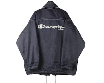 May include: A navy blue Champion jacket with a white embroidered logo that reads "Champion U.S.A."