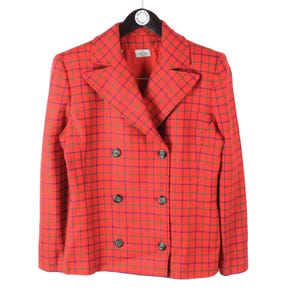 May include: A double-breasted blazer in a vibrant red fabric featuring a dark blue and green grid check pattern. The jacket includes wide lapels, long sleeves, and six dark buttons arranged in two vertical rows on the front of the garment.