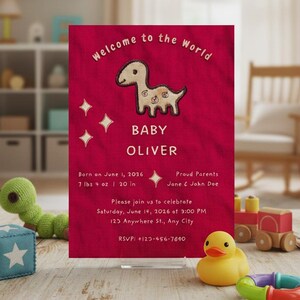 May include: A baby announcement card with a red background and the text "Welcome to the World." It features a stitched dinosaur illustration and the name "Baby Oliver." The card includes birth details: 7 lbs 4 oz, 20 in.