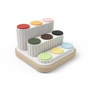 Puede incluir: Un juguete multinivel blanco y beige con acentos circulares coloridos. El juguete presenta c&iacute;rculos rojos, naranjas, rosas, negros, marrones, verdes, amarillos y azules. El juguete est&aacute; dise&ntilde;ado con una estructura escalonada.