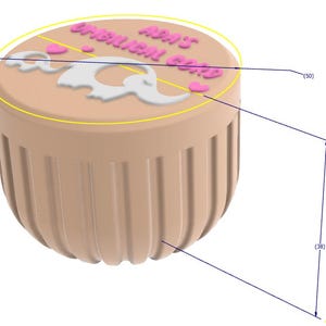 May include: A tan-colored container with a rounded bottom and vertical grooves. The top features the text "ADA'S UMBILICAL CORD" in pink, along with a white elephant design and pink hearts. The container is approximately 38 mm tall and 50 mm wide.
