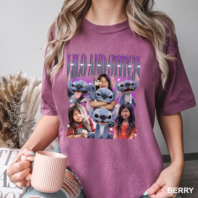 May include: Berry-colored t-shirt featuring a graphic of Stitch from Lilo & Stitch with the text "Lilo and Stitch". The graphic includes images of Stitch and children. The shirt is a comfortable, casual style.