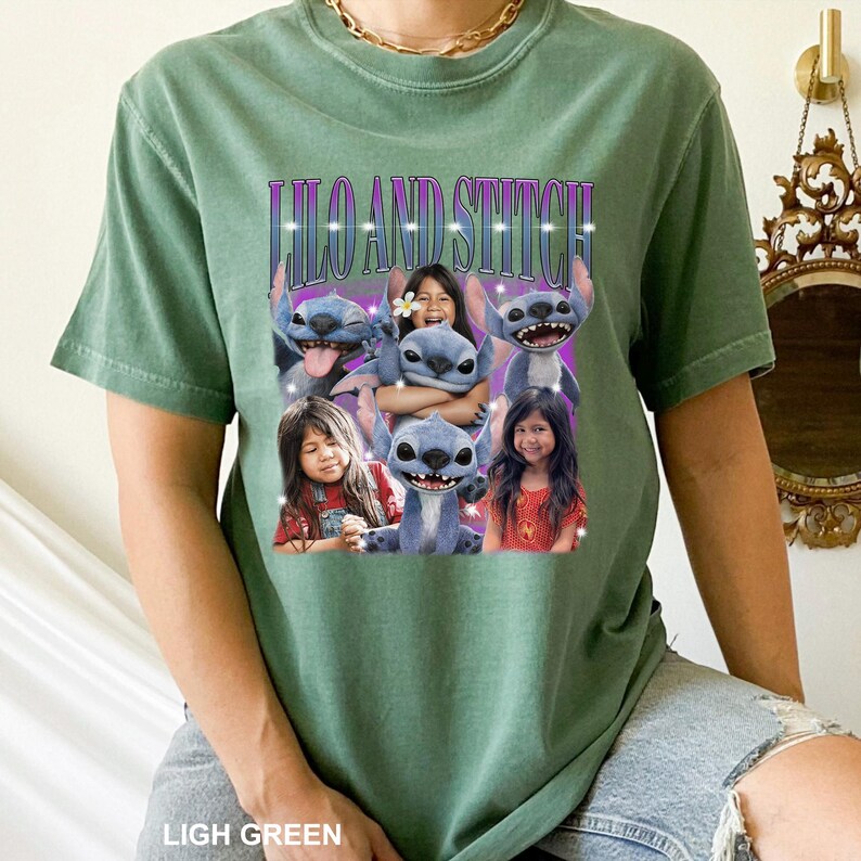 May include: Light green t-shirt featuring a graphic of Stitch from Lilo & Stitch with the text "Lilo and Stitch". The graphic includes images of Stitch and children. The shirt is made of a soft material.