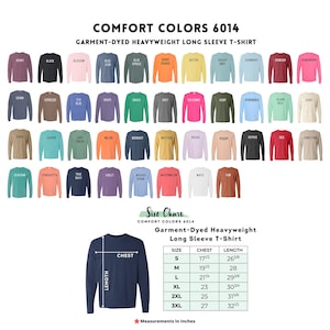 The image is a color chart for a garment-dyed, heavyweight long sleeve t-shirt. It displays a variety of different colored t-shirts, each with a corresponding size chart indicating the chest, length, and sleeve measurements. The chart provides a visual representation of the different color options available for the t-shirt, allowing customers to choose their preferred color based on their size.