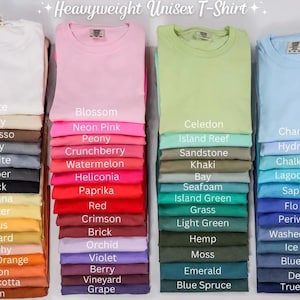 a collection of colorful t-shirts, each with a different color and design, arranged in two rows.