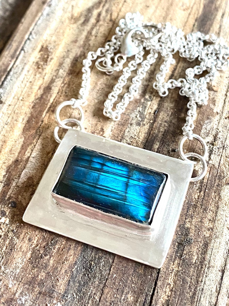 teal and blue mixture of colors in labradorite enveloped by sterling silver.