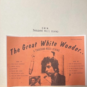 May include: A vintage record album cover with an orange background featuring a black and white photo of Bob Dylan. The album title is "The Great White Wonder" with the text "A Thousand Miles Behind..." below it. The album is by G.W.W. and lists the songs on each side of the record.