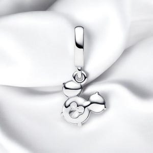 May include: Silver charm featuring a Mickey Mouse silhouette with a clear crystal in the center. The charm is designed to be attached to a bracelet or necklace.
