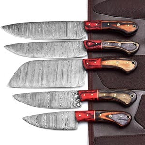 May include: Set of five kitchen knives with Damascus steel blades and red wood handles. The knives are arranged in a leather roll.
