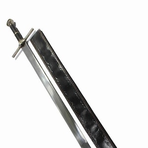 May include: A silver sword with a black leather scabbard. The sword has a cross guard and a pointed tip. The scabbard has a decorative pattern.