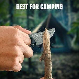 May include: A camping knife with a patterned blade is used to carve a wooden stick. The text "BEST FOR CAMPING" is displayed above the knife. The background is blurred, showing a tent and trees.