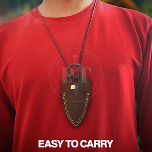 May include: A brown leather necklace with a small knife in a matching sheath. The sheath is stitched with white thread and hangs from a brown leather cord. The text "EASY TO CARRY" is at the bottom of the image.