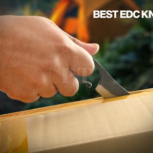 May include: A small, dark-colored EDC knife cutting into a cardboard box. The knife has a curved blade and a loop at the end of the handle. The text "BEST EDC KNIFE" is visible in the upper right corner.