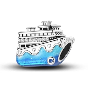 May include: A silver-coloured charm in the shape of a cruise ship. The ship has a blue, glittery base, and a row of clear stones. The ship has multiple decks and a detailed design, perfect for a nautical theme.