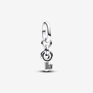 May include: A silver-colored charm in the shape of a key. The charm has a circular top with a keyhole design and a rectangular key bit. The charm is suspended from a ring. Jewelry.