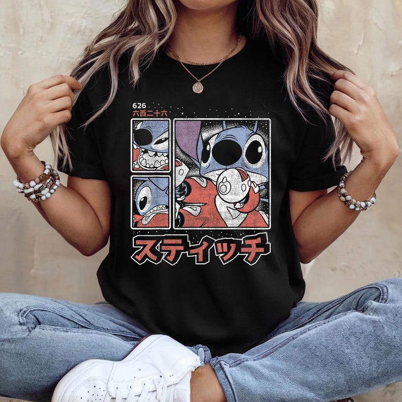 May include: Black t-shirt with a graphic of the character Stitch from Lilo & Stitch. The design includes multiple panels with Stitch's face and Japanese text. The shirt has short sleeves and a crew neck.