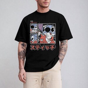 May include: Black t-shirt with a graphic of a blue alien character and a red alien character in a four-panel design. The graphic includes Japanese text and the number "626".