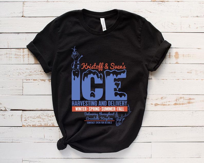 May include: Black t-shirt with a blue and white graphic of Kristoff and Sven's Ice Harvesting and Delivery. The text says "Delivering throughout Arendelle Kingdom. Contact Sven for details."
