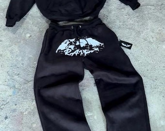 May include: Black hooded sweatshirt and matching sweatpants with a white graphic print of the word "RARE" on both pieces.
