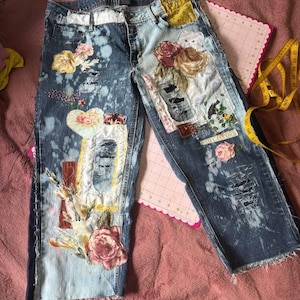 May include: A rustic wooden sign with the text "Welcome" in a handwritten style. The sign is painted white with a distressed finish, and features a decorative floral design in the corner. The sign is designed to be hung on a wall or door.