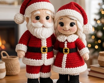 May include: Crocheted Santa Claus and Mrs. Claus dolls. Santa wears a red suit with white trim, a black belt with a gold buckle, and a matching hat. Mrs. Claus has a similar outfit with a white collar and blonde hair. They stand on a white crocheted base.