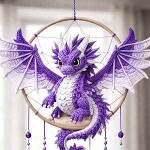May include: A handcrafted dreamcatcher featuring a purple and white crocheted dragon with outstretched wings. The dragon sits within a wooden hoop, with hanging purple and white feathers and decorative beads. A whimsical, decorative item.